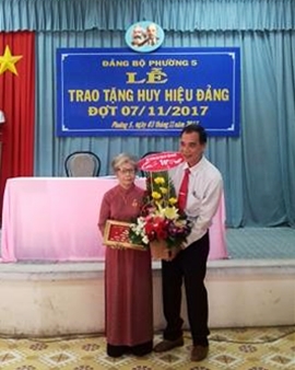 Đồng chí Nguyễn Thanh Hiền - Phó trưởng ban Thường trực Ban Tuyên giáo Tỉnh ủy tặng khánh vàng và hoa chúc mừng